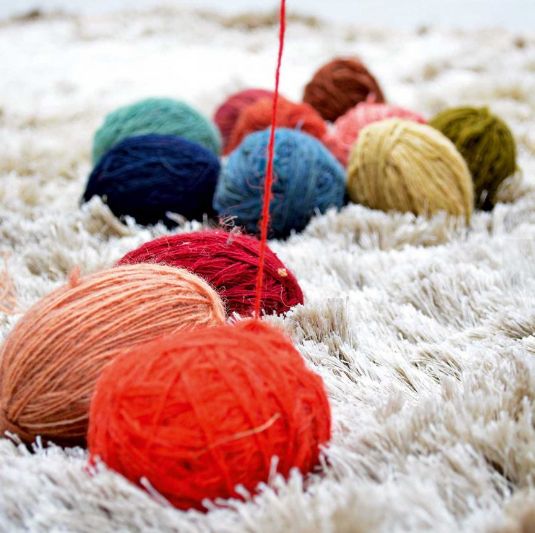 The dyed woollen yarn, rolled into balls, ready to be used on the loom.